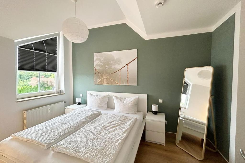 a bedroom with a bed and a bridge painting on the wall at Ferienwohnung an der Messe *inkl. Garage* in Erfurt