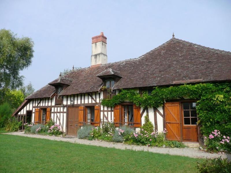a large white and brown house with a chimney at Au clos de marie in Lusigny-sur-Barse
