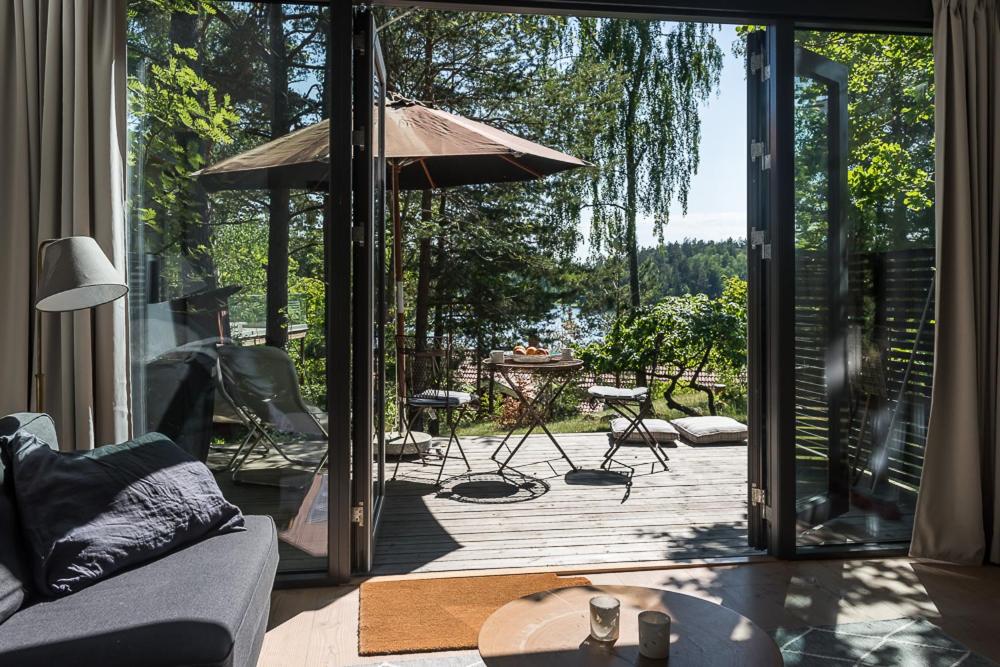 - un salon avec une porte s'ouvrant sur une terrasse dans l'établissement Sea view Myttinge, à Värmdö