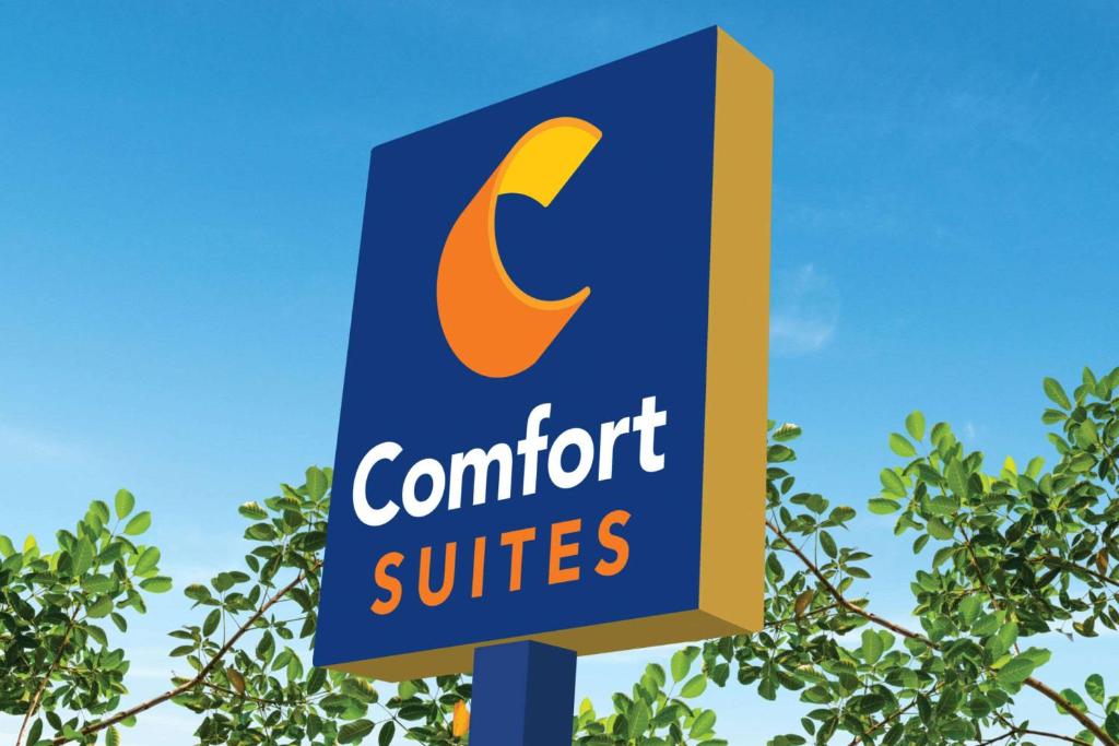 a sign for a comfort suites in front of a tree at Comfort Suites Denver North - Westminster in Westminster