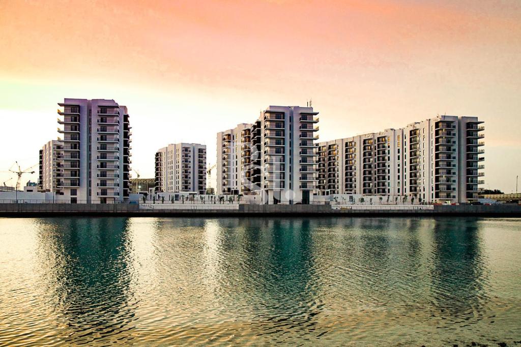 a group of tall buildings next to a body of water at Sea World Yas Island Luxury Holiday Apartment 915 in Abu Dhabi