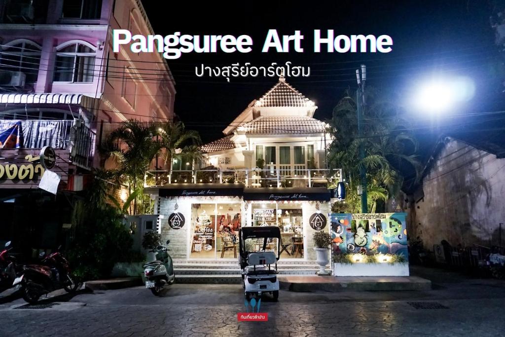 a shop in a street at night with the words panvez art home at Pangsuree Art Home in Lampang