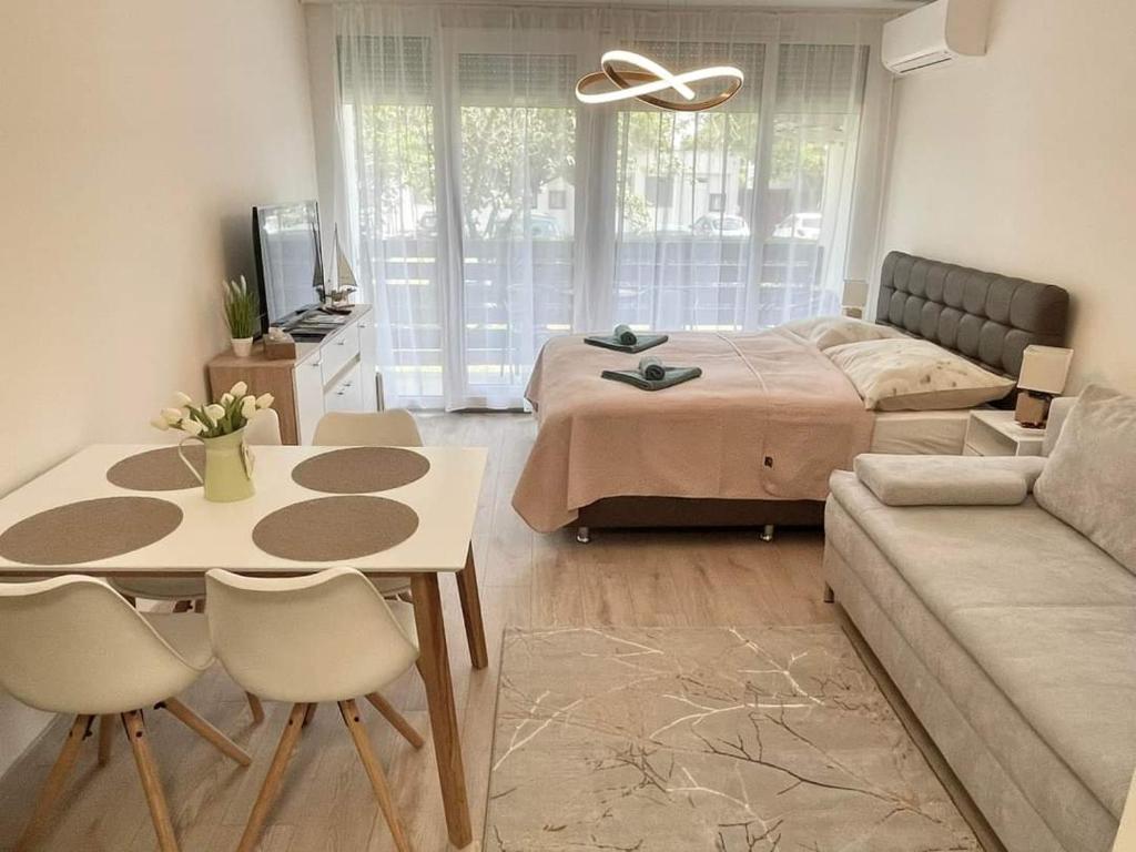 a bedroom with a bed and a table and a couch at Bella Luna in Balatonfüred