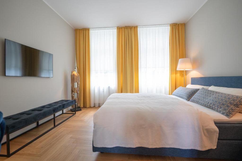 a bedroom with a bed and a flat screen tv at Pssst ! Geheimtip in Rüttenscheid in Essen