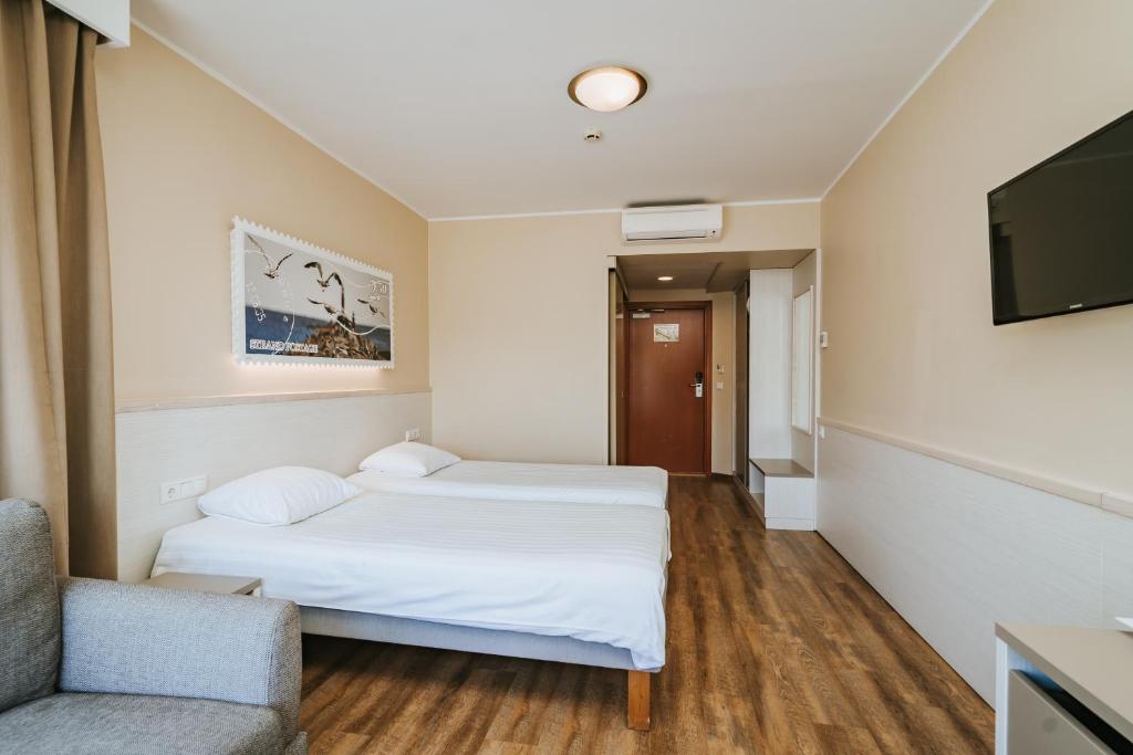 A bed or beds in a room at Hestia Hotel Strand