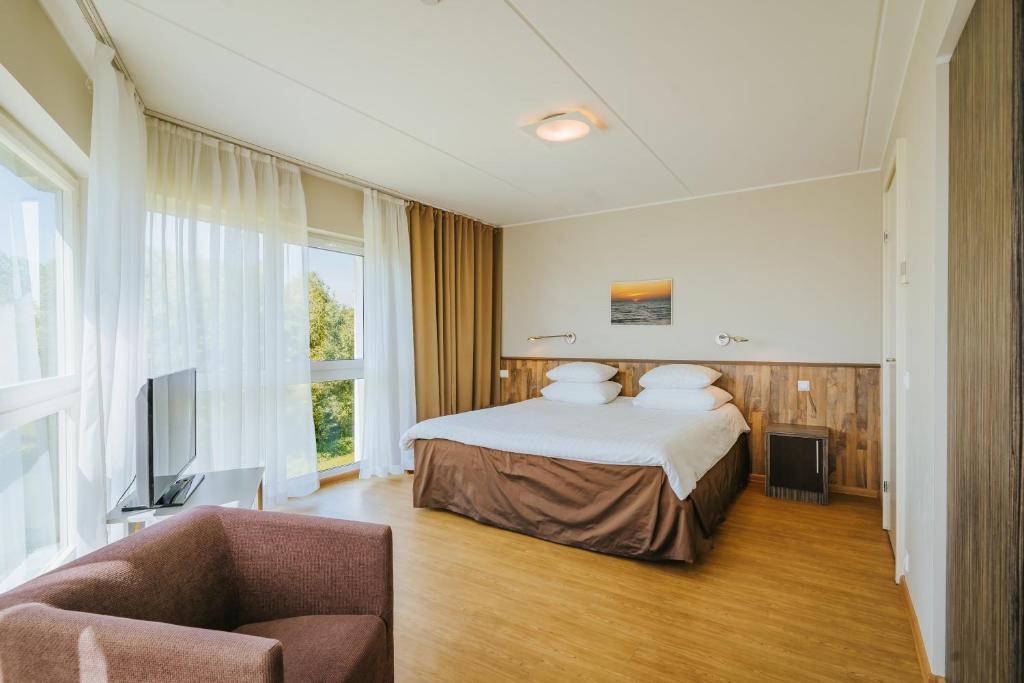 A bed or beds in a room at Hestia Hotel Strand