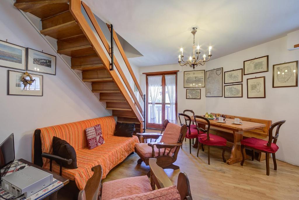 a living room with an orange couch and a table at Il Rododendro City Center - Happy Rentals in Bardonecchia