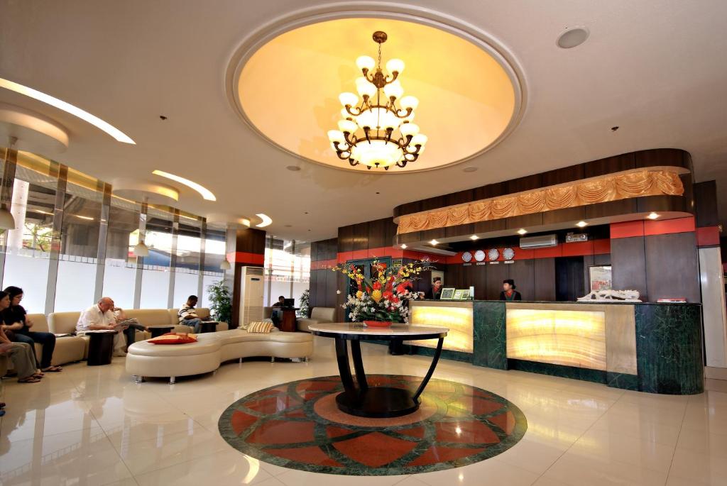 a lobby of a hotel with a table in the middle at Eurotel Makati in Manila