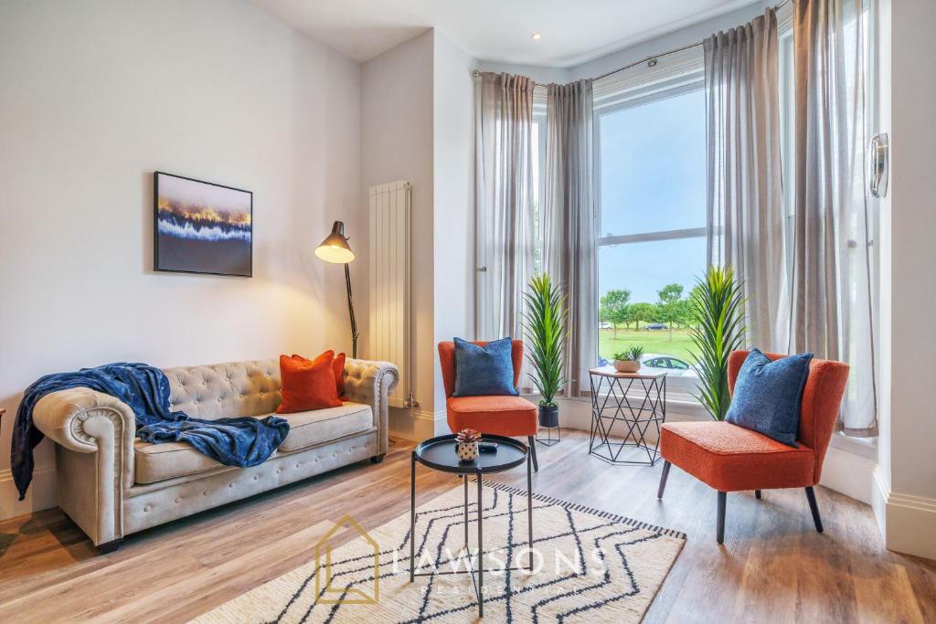 a living room with a couch and chairs and a large window at Executive Living by Lawsons 3 Bed, 3 Bath Apartment in Portsmouth