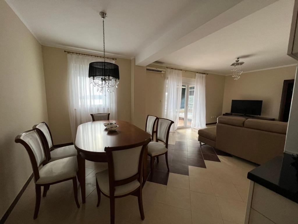 a living room with a table and chairs and a couch at Przno apartment in Budva