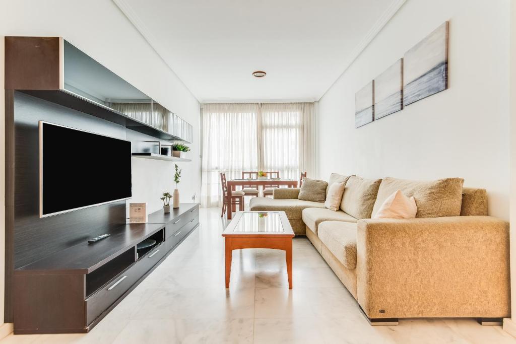 sala de estar con sofá y TV de pantalla plana en Home2Book Comfy Apartment Las Palmas Center Triana, en Las Palmas de Gran Canaria