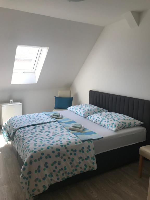 a bedroom with two beds and a skylight at Apartmán Pod Věží in Telč