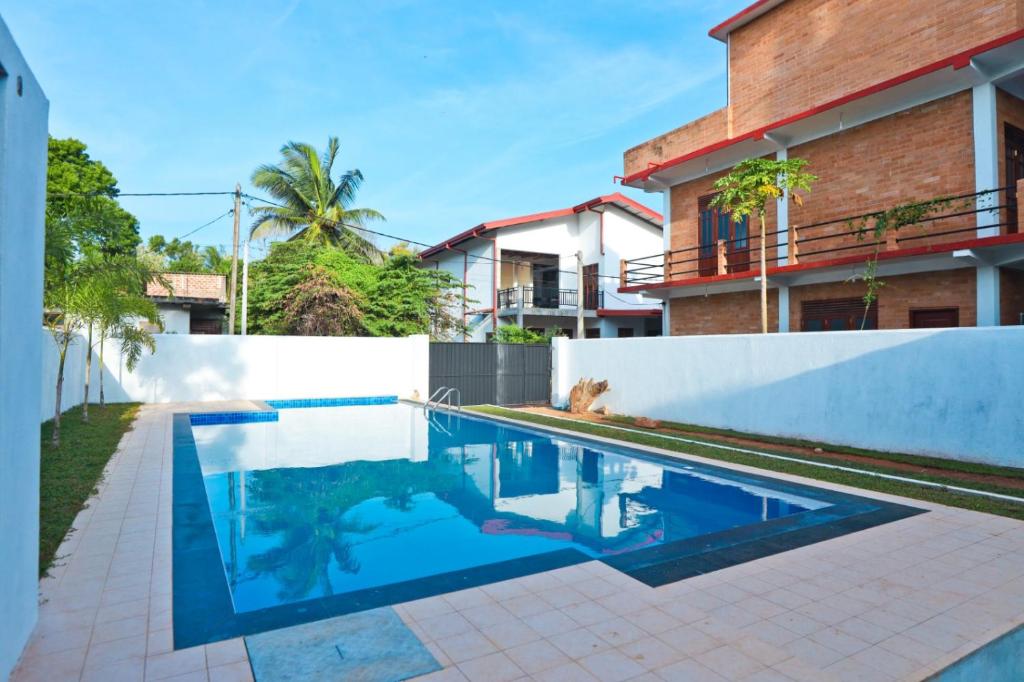a swimming pool in front of a house at Thinaya lake resort in Anuradhapura