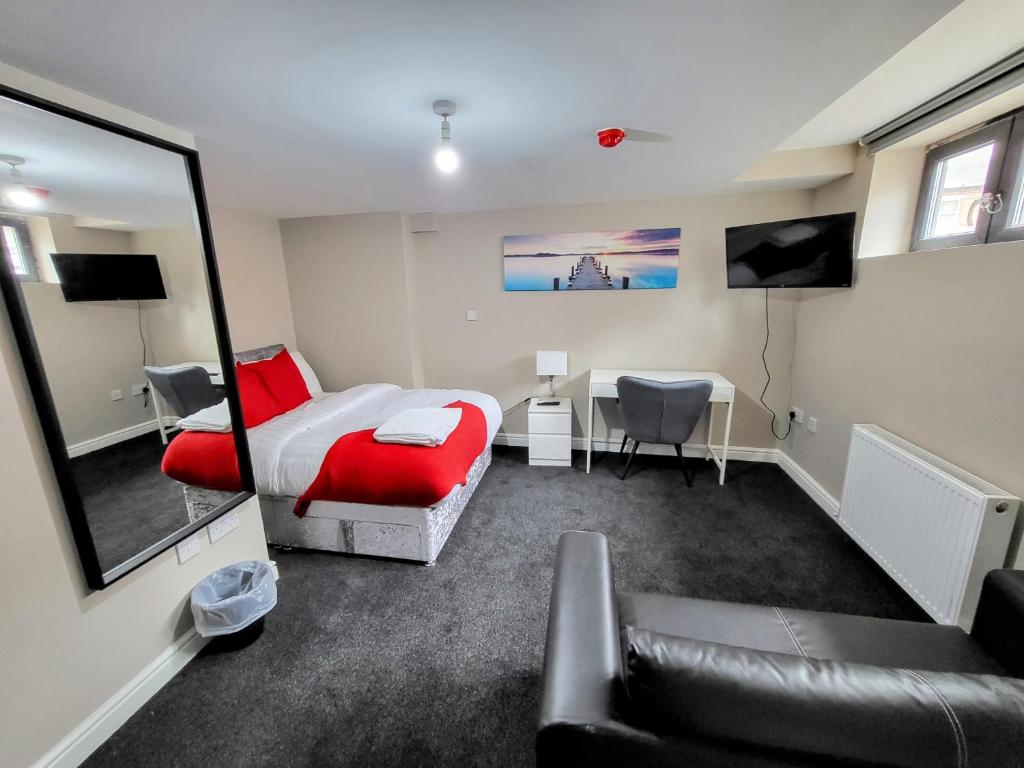 a bedroom with a bed and a desk and a couch at Stay Sleep Rest - NG2 in Nottingham