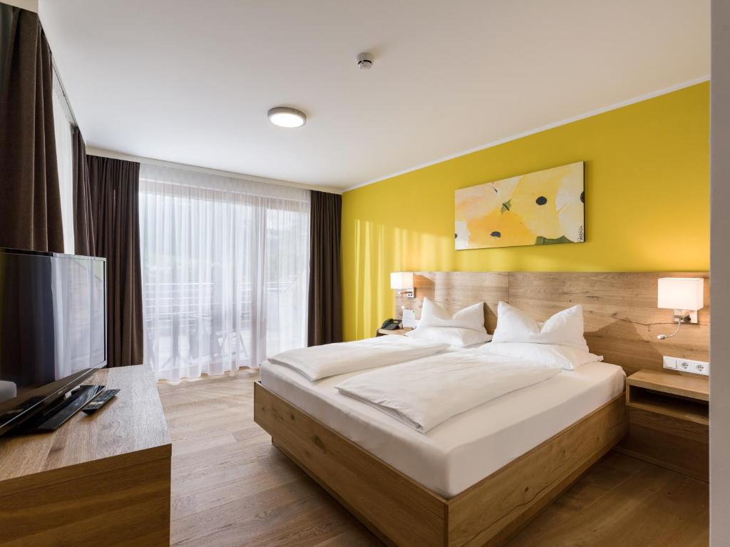 Letto o letti in una camera di DAS SIEBEN - Adults Only