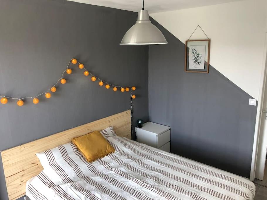 - une chambre avec un lit doté d'un oreiller jaune dans l'établissement Thiais/Orly: grand F2 lumineux, à Thiais