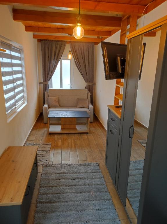 a living room with a couch and a table at The little White House in Sibiu