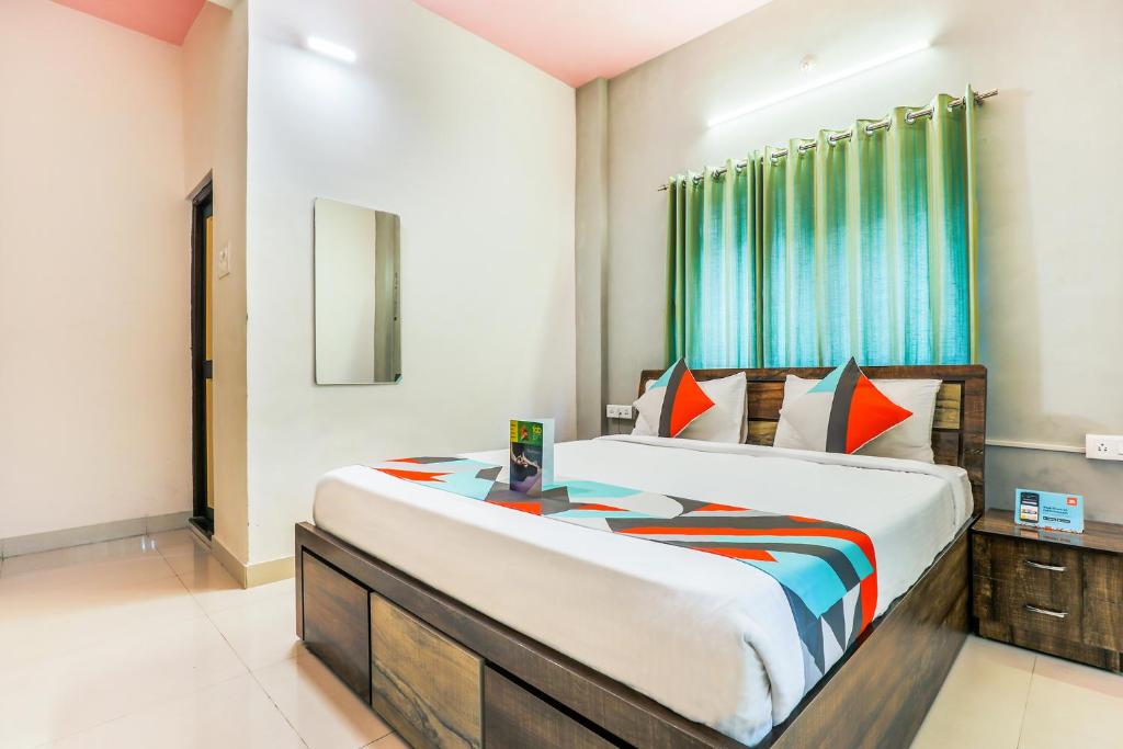 ein Schlafzimmer mit einem großen Bett und einem Fenster in der Unterkunft FabExpress Diamond Residency in Pune