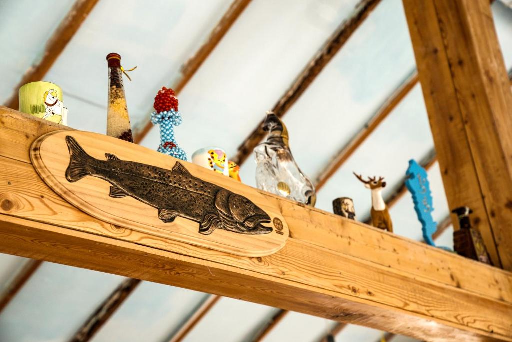 a wooden shelf with bottles and a fish on it at Nature Door Resort, Khuvsgul province, Mongolia 