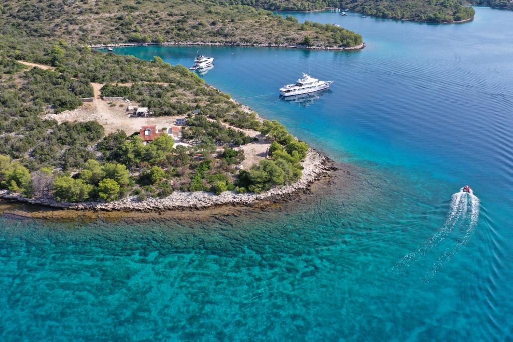 an island with two boats in the water at Vacation house Punta sunca in Stari Grad