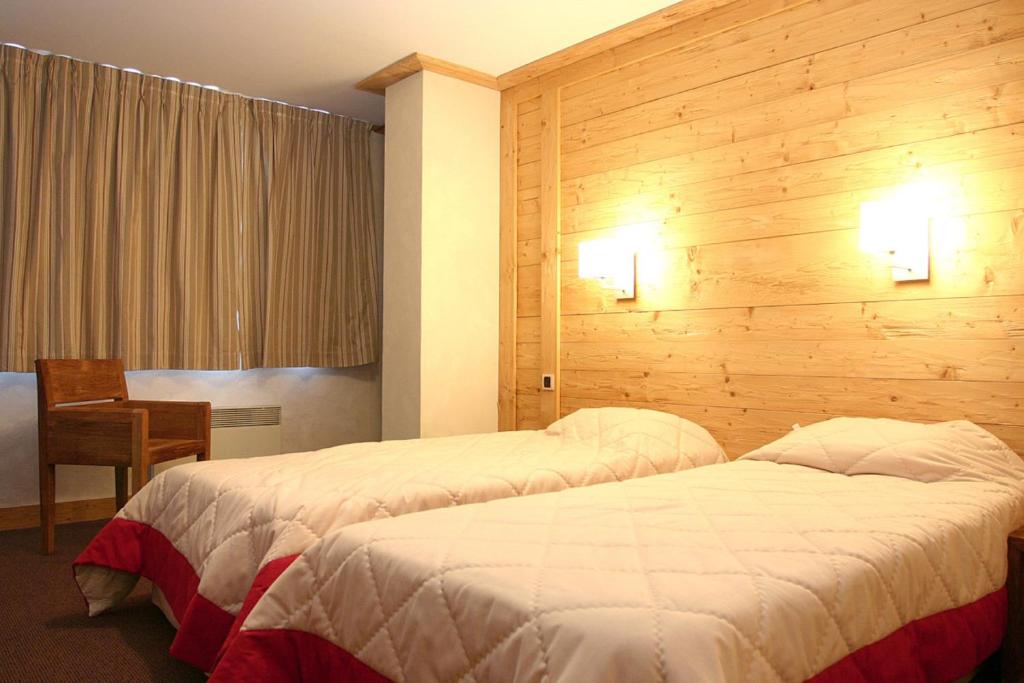 Postel nebo postele na pokoji v ubytování Vacancéole - Résidence Cortina