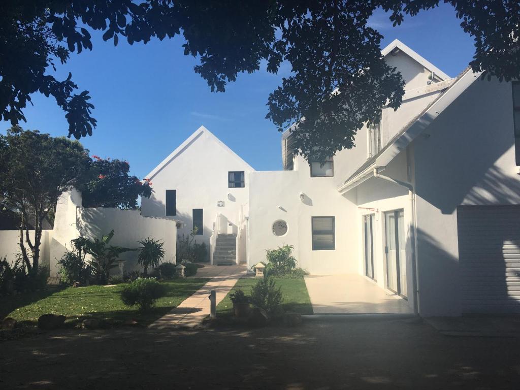 a white house with a driveway at Summerhill Self-Catering Accommodation St Francis Bay in St Francis Bay