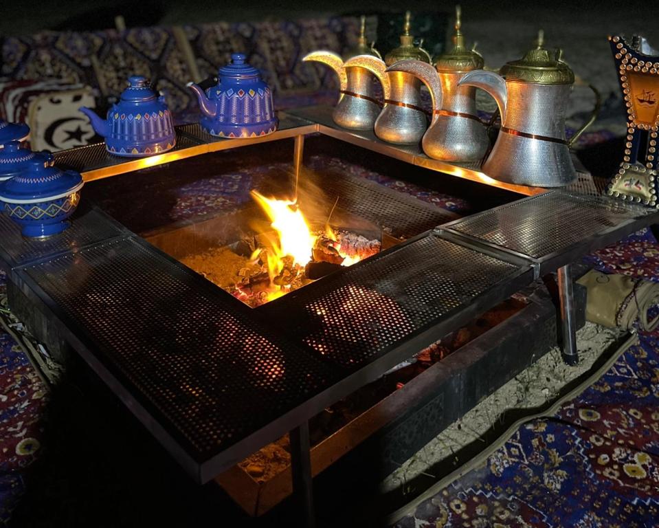 a fireplace with a fire in the middle at the desert 