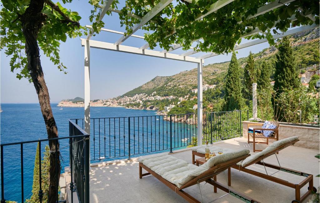 a patio with a view of the ocean at Beautiful Apartment In Dubrovnik With Jacuzzi in Dubrovnik