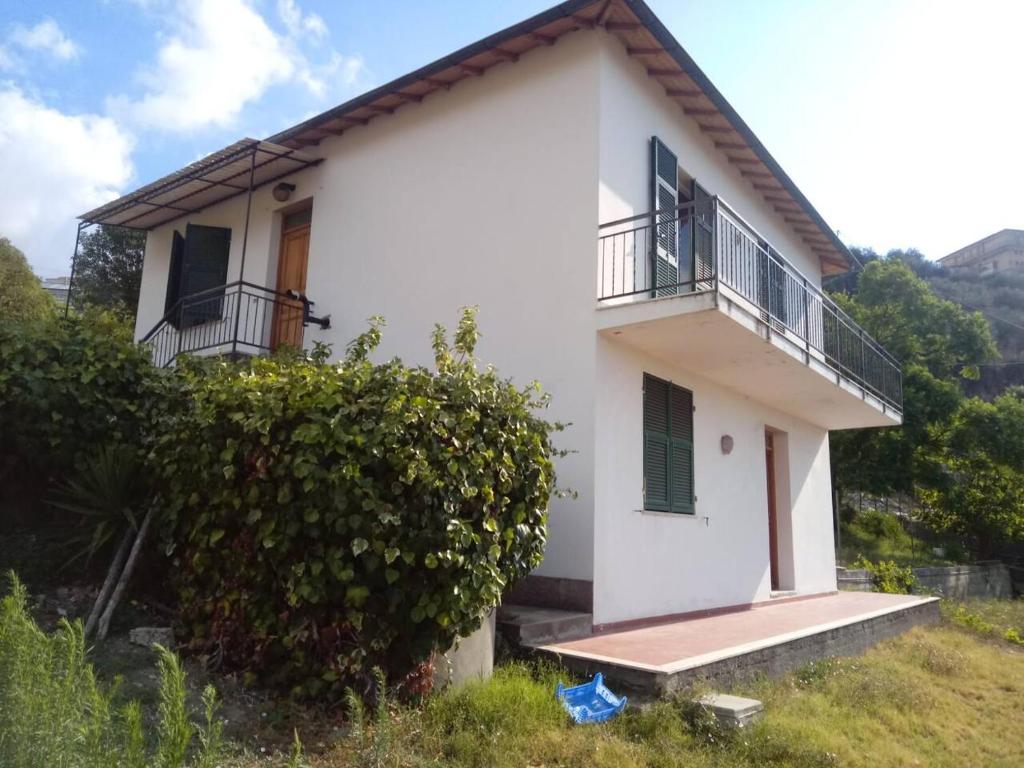 a white house with a balcony on a hill at Villetta Alberti in Sanremo
