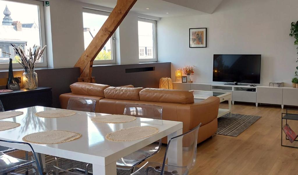 a living room with a couch and a table at The Roof - Rooftop appt in historical center in Antwerp