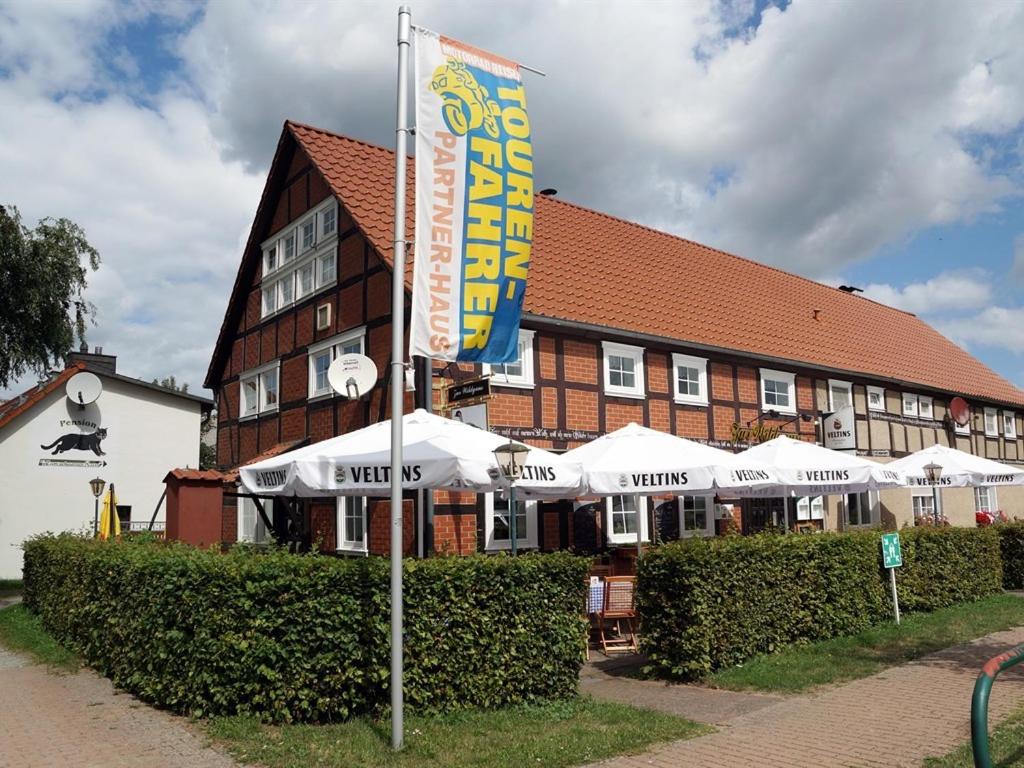 a hotel with a flag in front of a building at Zur Wildgans in Arendsee