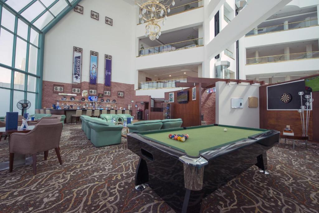 a billiard room with a pool table at Mirfa Hotel in Al Mirfa