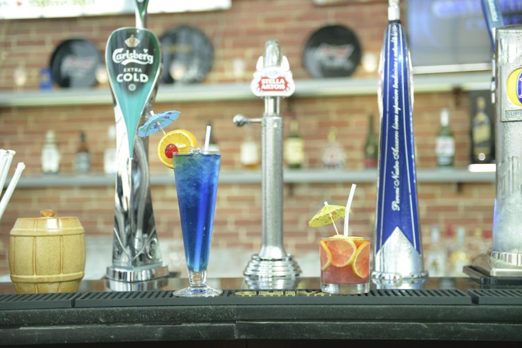 a table with different types of glasses on it at Mirfa Hotel in Al Mirfa