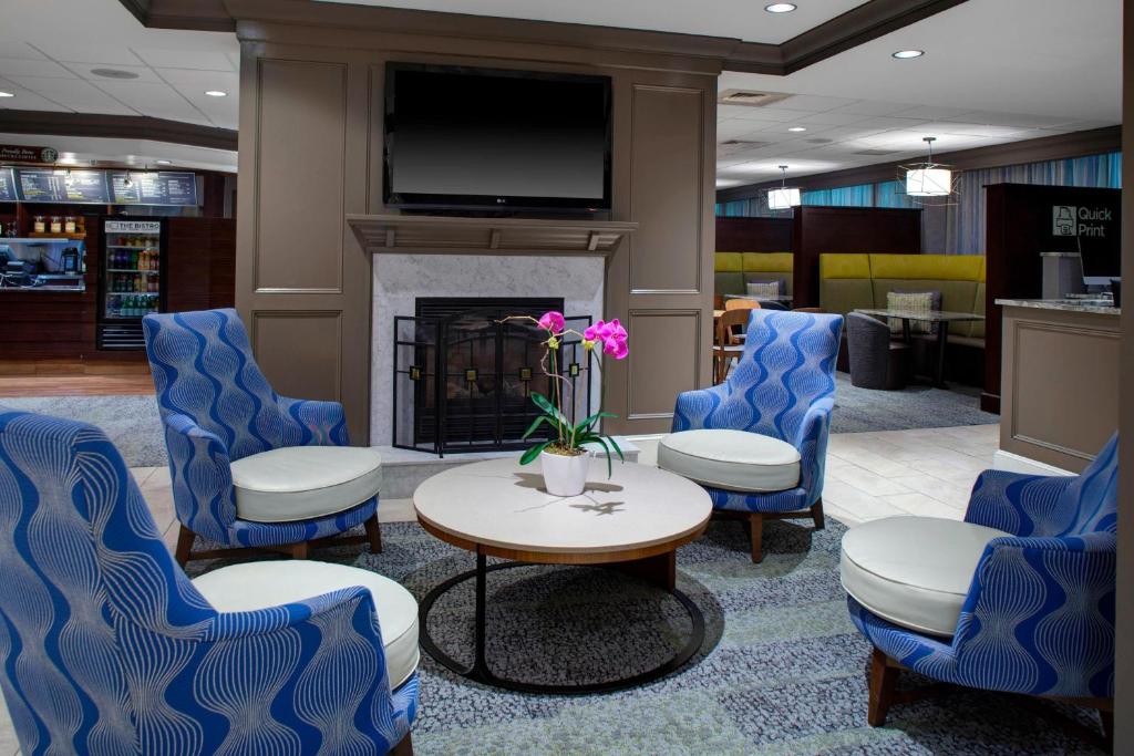 a lobby with chairs and a table and a fireplace at Courtyard New Haven at Yale in New Haven