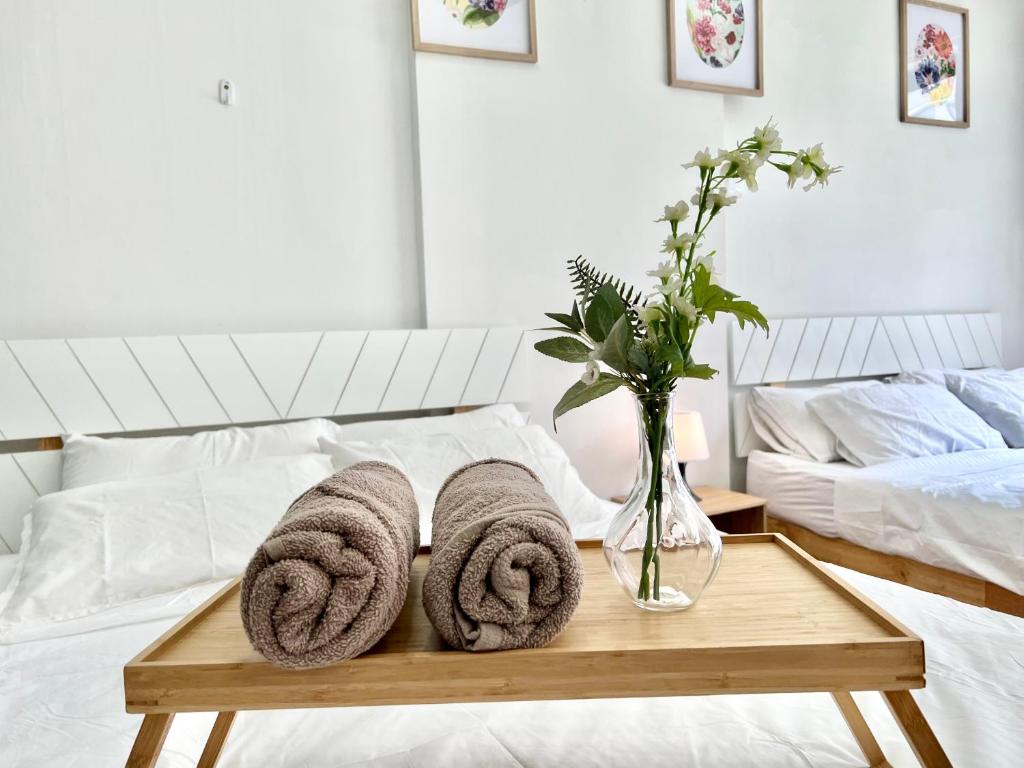 a bed with a wooden tray with towels on it at G3 1-6Pax Cozy Home Sunway Medical Center GEO Wifi 2QBeds in Kampong Penaga