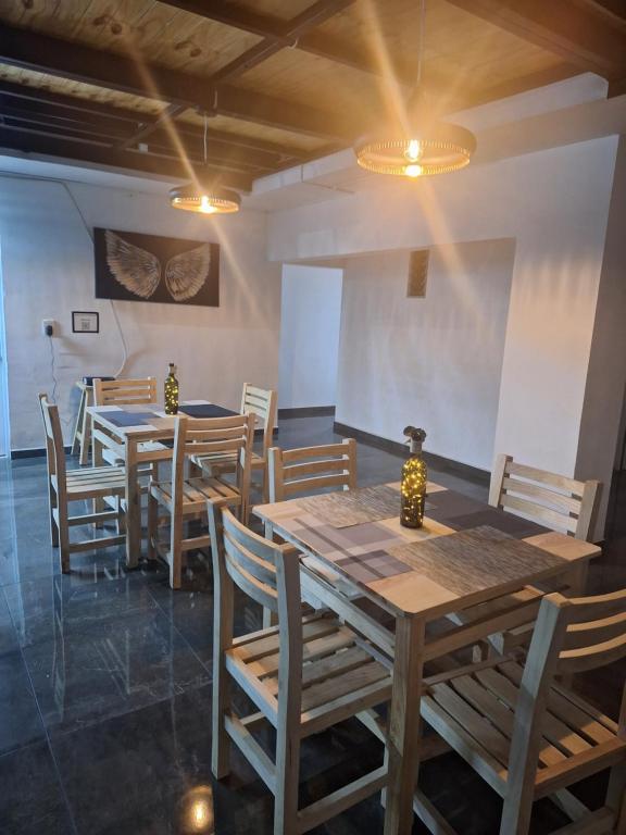 a dining room with wooden tables and chairs at Loft atardecer in Uruapan del Progreso