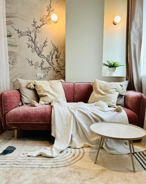 a red couch in a living room with a table at Ultracentral Lux Boutique 1BR Ap Near Subway in Bucharest