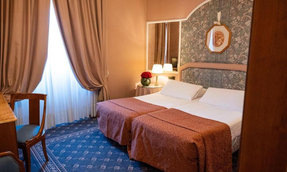 Postel nebo postele na pokoji v ubytování Hotel Mecenate Palace
