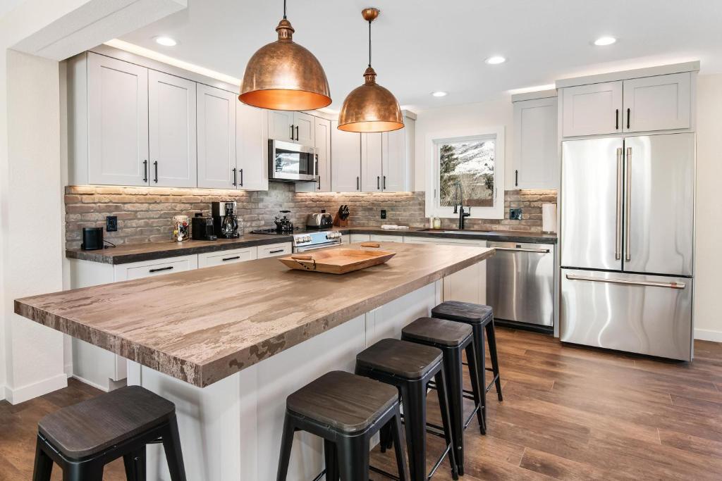a kitchen with a large kitchen island with bar stools at 1536-A Deer Blvd in Avon