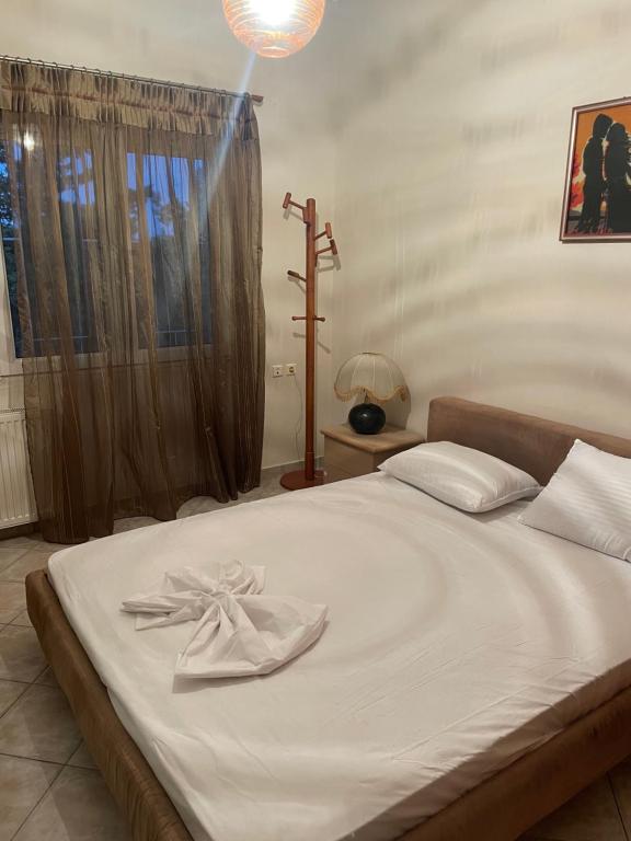 a bed with a white towel on top of it at Villa Marisia in Chios