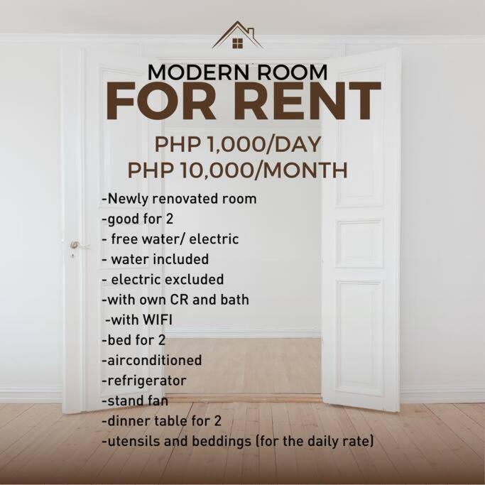 eine weiße Tür mit einem Schild für ein modernes Zimmer zur Miete in der Unterkunft Perfect for Couples Room in Cebu City