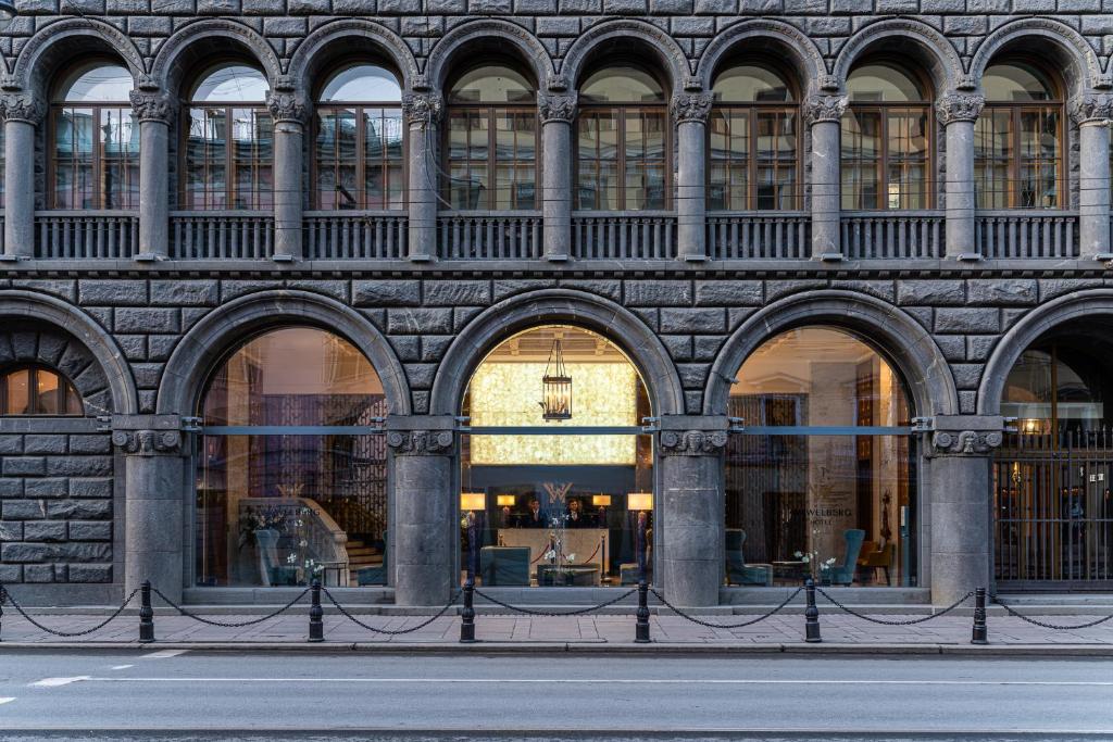 a building with arches on the side of a street at Отель Wawelberg in Saint Petersburg