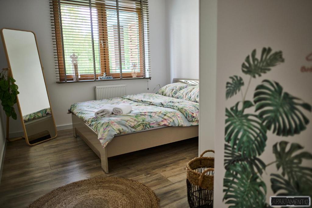 a small bedroom with a bed and a window at Apartament 12 in Chojnice