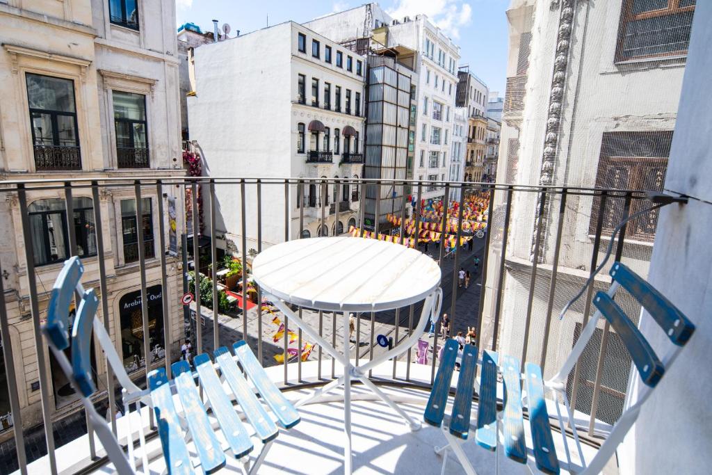 a table and chairs on a balcony with buildings at Stay Lab Taksim in Istanbul