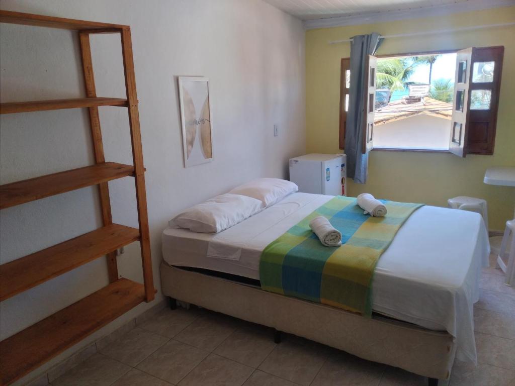 a bedroom with a bed with a ladder and a window at Aconchego da Vovó Netinha in Maragogi