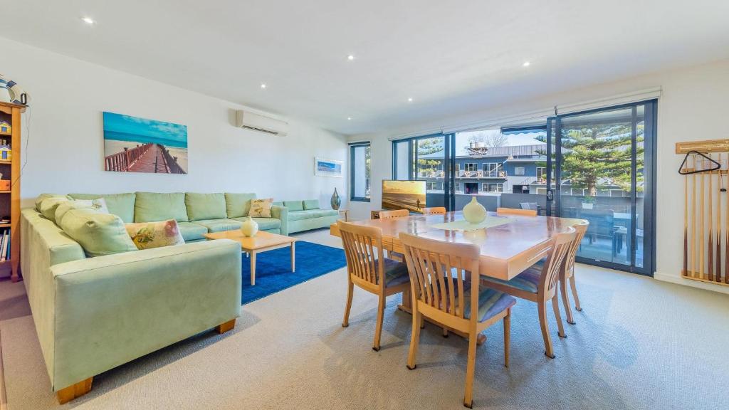 a living room with a table and a couch at 4-4 The Esplanade, Cowes - Cscape in Cowes