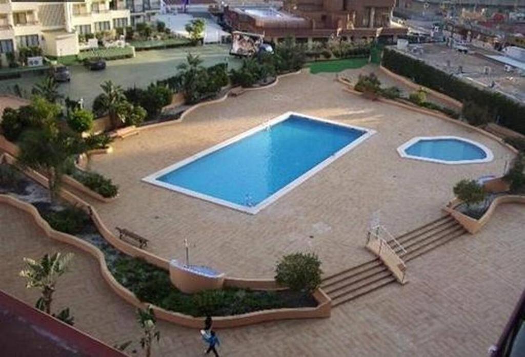 an overhead view of a large swimming pool in a building at Torremar 17 vistas al mar Benidorm in Benidorm