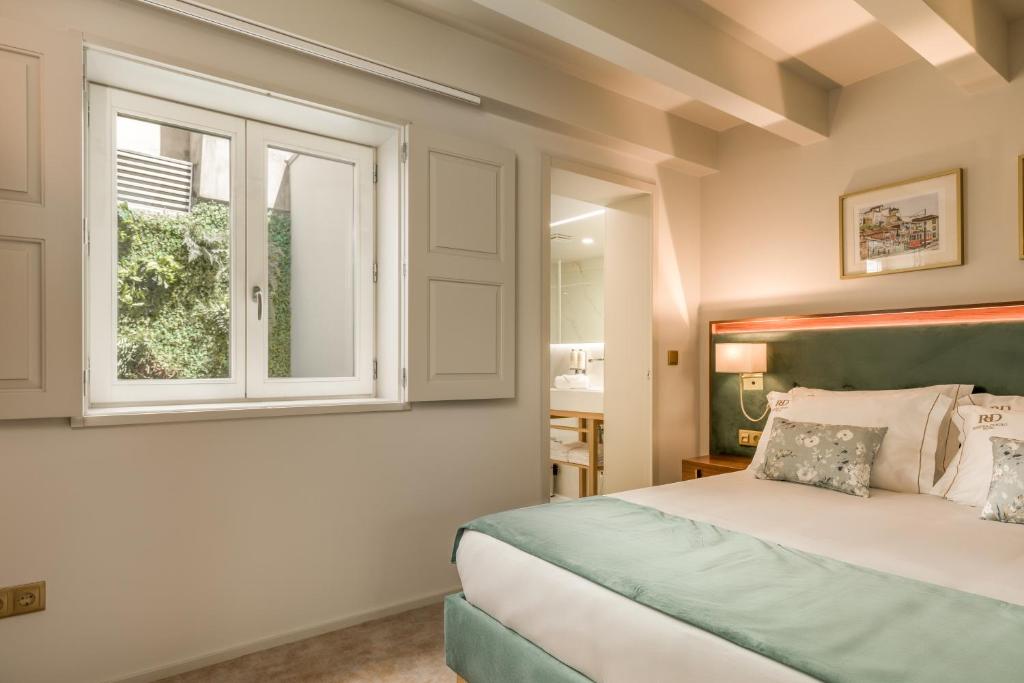 Postel nebo postele na pokoji v ubytování Ribeira Douro Hotel