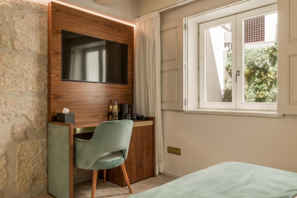 Postel nebo postele na pokoji v ubytování Ribeira Douro Hotel