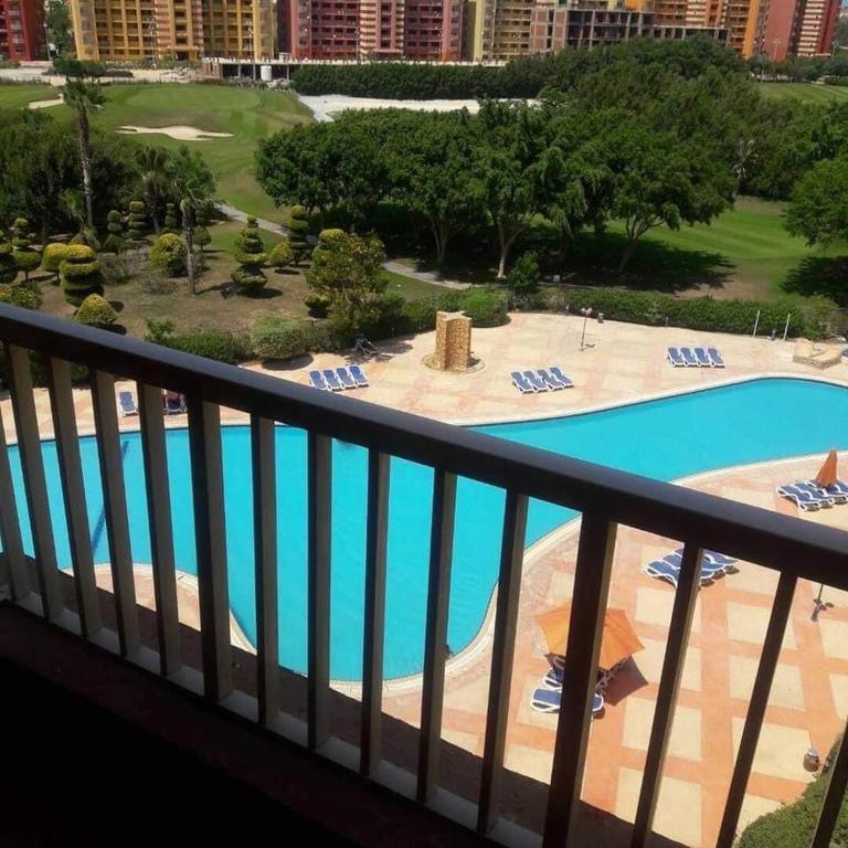 a view from the balcony of a resort with a pool at Gulf Porto Marina Call First in El Alamein